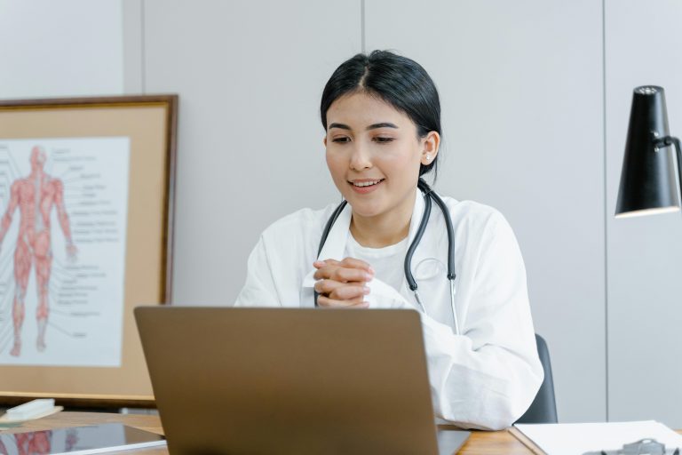 Informational graphic about the Qualified Medical Evaluator (QME) Exam, including a description of its purpose for physicians in California’s workers' compensation system. The image features a smiling female doctor in a white coat with a stethoscope around her neck, holding a clipboard.